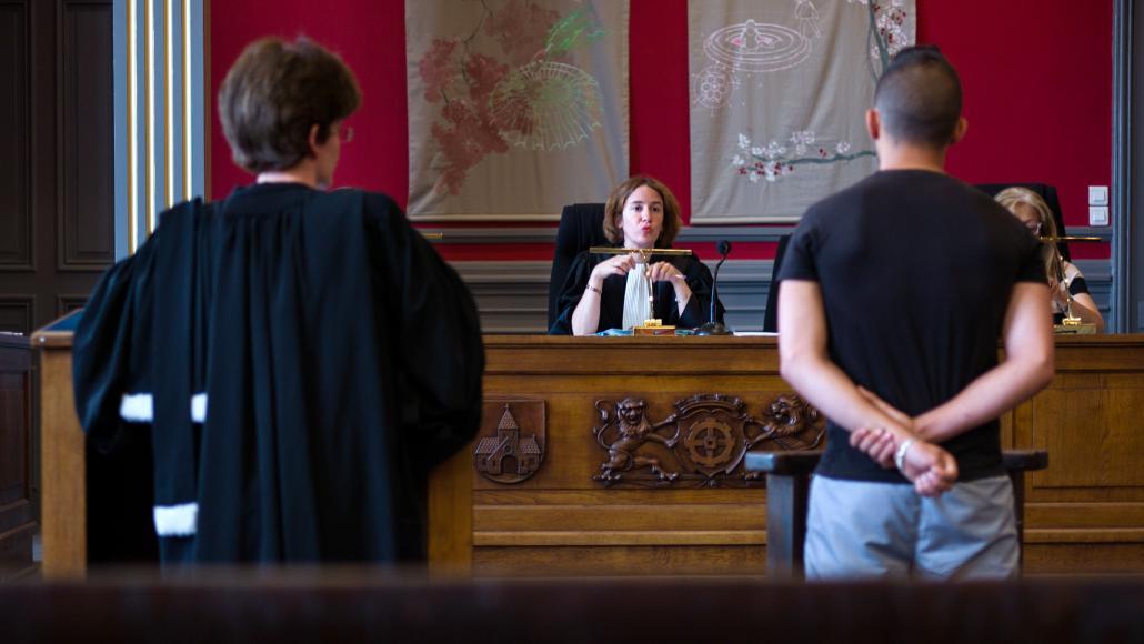 A judge speaks to a youth during a hearing at the children's court in Mulhouse on June 26, 2013. AFP PHOTO / SEBASTIEN BOZON