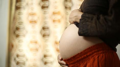Image d'illustration : Une femme enceinte se tient le ventre